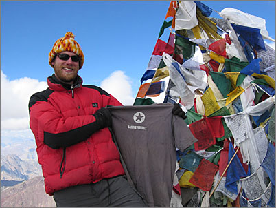 Eric Case, proudly displaying his DF T-shirt atop Stok Kangri in the Himalayas.