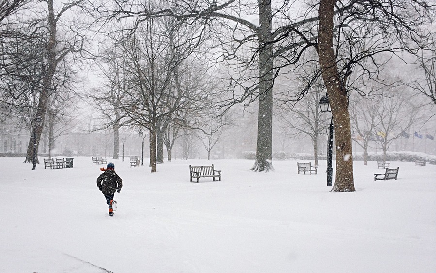 My boy running through an empty Washington Square in the snow.