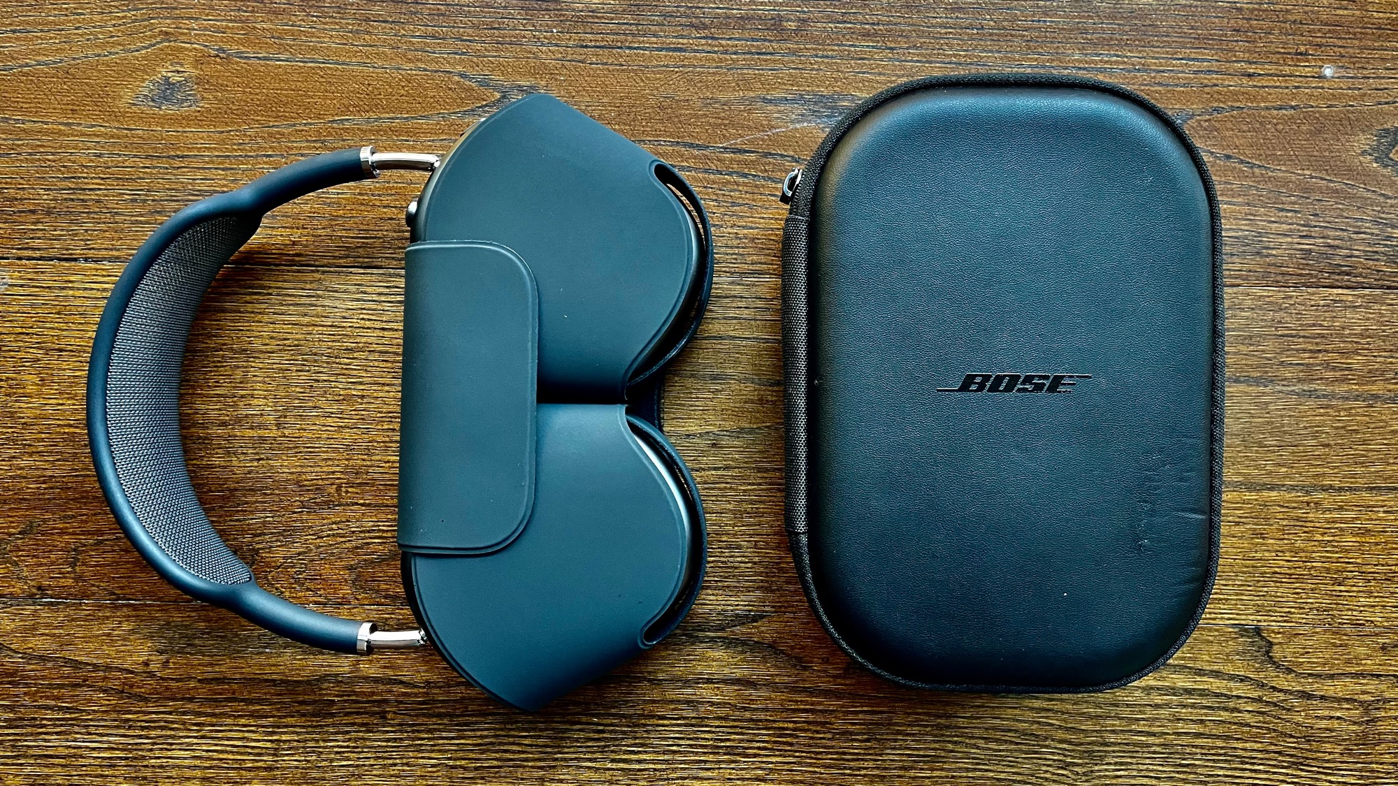 Side-by-side shot of AirPods Pro and Bose QC35’s, both in their respective cases.