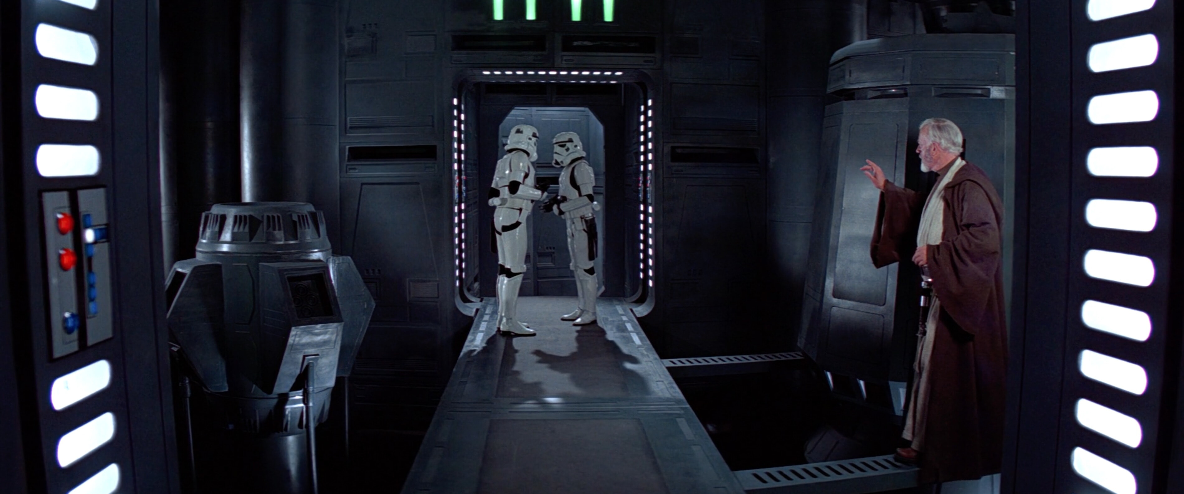 Obi-Wan Kenobi, using his hand to create an audio distraction to escape the attention of two stormtroopers near the Death Star’s tractor beam control panel.