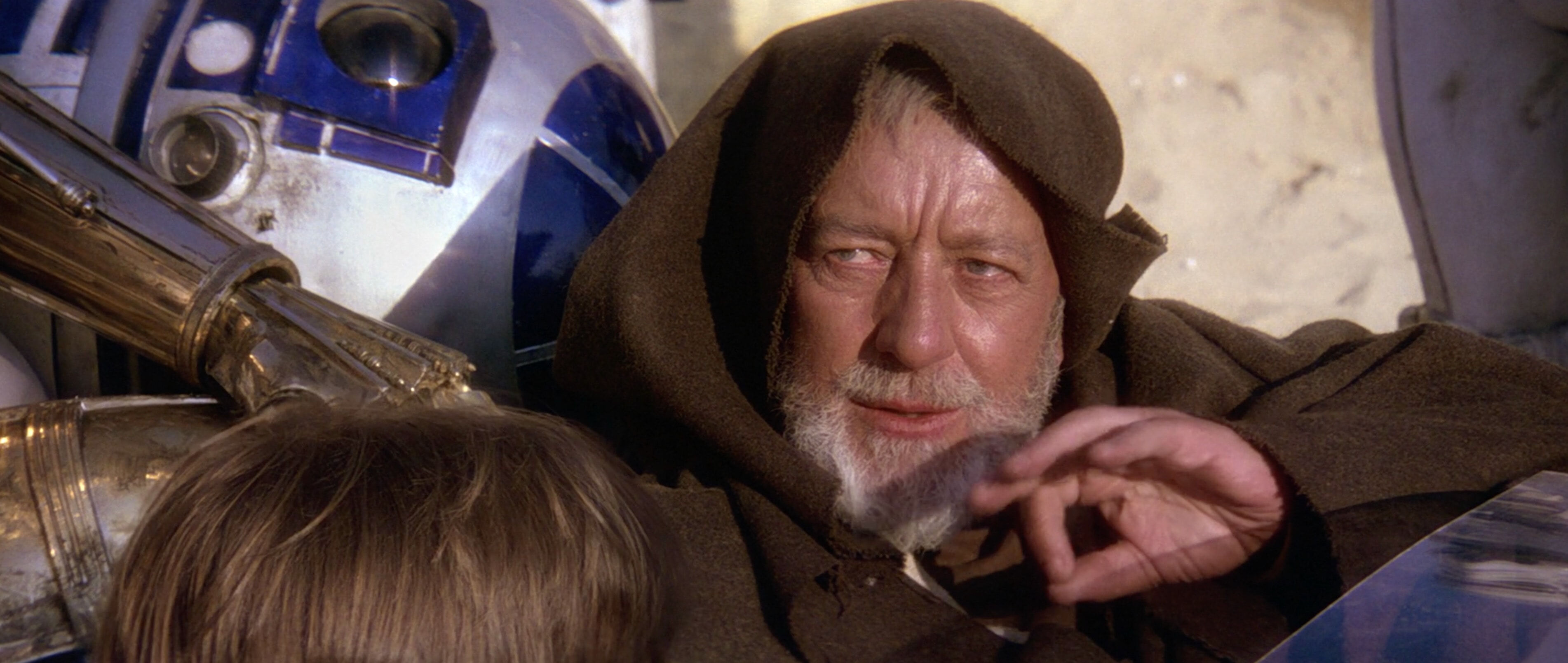 Obi-Wan Kenobi, gesturing to use the Force in the “these aren’t the droids you’re looking for” scene in “Star Wars”.