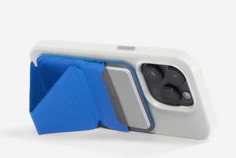 A blue Moft Snap-On iPhone Stand, propping an iPhone vertically.